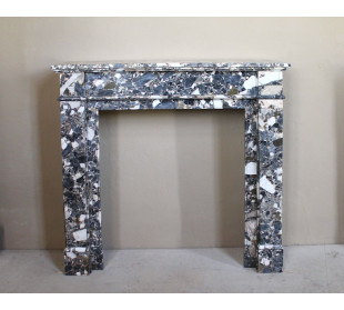 Antique Neoclassical marble fireplace, with minimalist lines and elegant multicolored veining on a dark background.