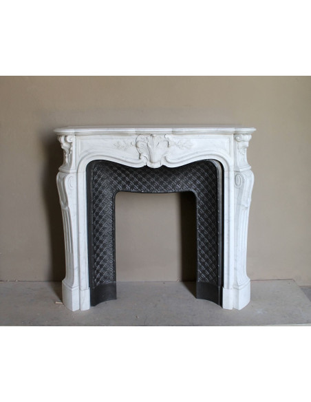 Antique Baroque “Olive Branch” fireplace mantel in white Carrara marble, with its original “Tapisserie” cast-iron insert.