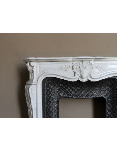 Antique Baroque “Olive Branch” fireplace mantel in white Carrara marble, with its original “Tapisserie” cast-iron insert.