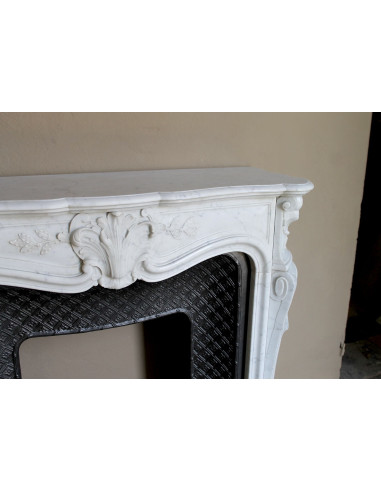 Antique Baroque “Olive Branch” fireplace mantel in white Carrara marble, with its original “Tapisserie” cast-iron insert.