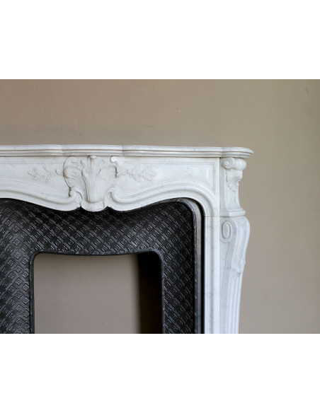 Antique Baroque “Olive Branch” fireplace mantel in white Carrara marble, with its original “Tapisserie” cast-iron insert.