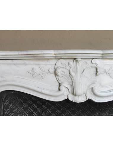 Antique Baroque “Olive Branch” fireplace mantel in white Carrara marble, with its original “Tapisserie” cast-iron insert.