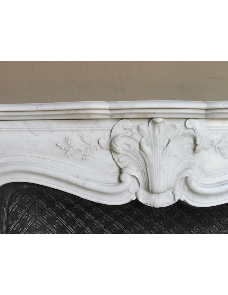 Antique Baroque “Olive Branch” fireplace mantel in white Carrara marble, with its original “Tapisserie” cast-iron insert.