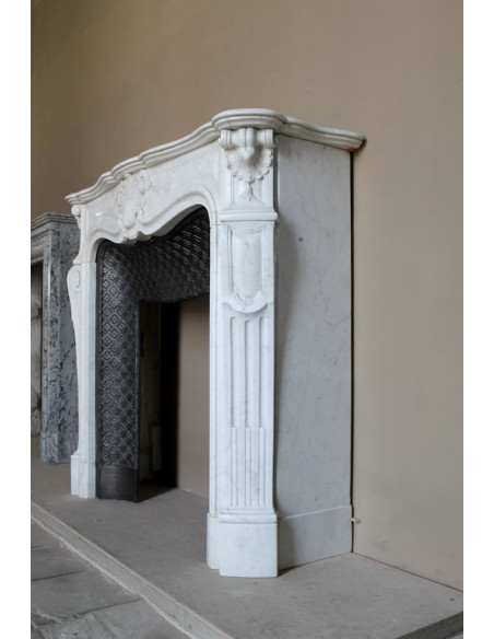 Antique Baroque “Olive Branch” fireplace mantel in white Carrara marble, with its original “Tapisserie” cast-iron insert.