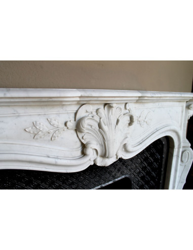 Antique Baroque “Olive Branch” fireplace mantel in white Carrara marble, with its original “Tapisserie” cast-iron insert.