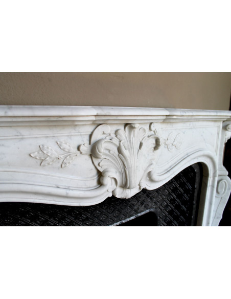 Antique Baroque “Olive Branch” fireplace mantel in white Carrara marble, with its original “Tapisserie” cast-iron insert.