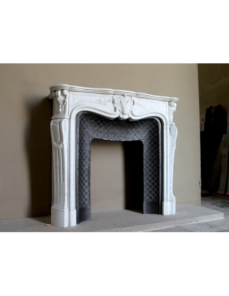 Antique Baroque “Olive Branch” fireplace mantel in white Carrara marble, with its original “Tapisserie” cast-iron insert.
