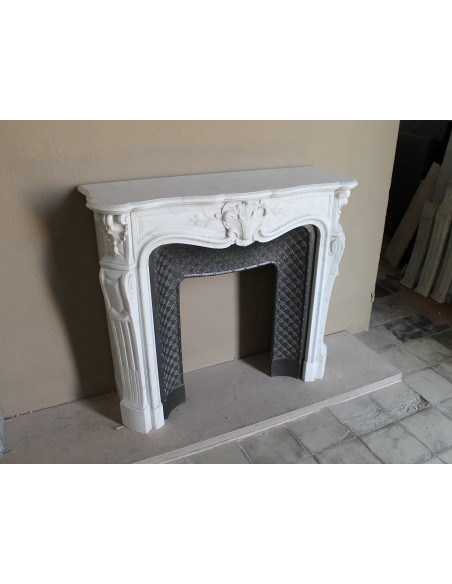 Antique Baroque “Olive Branch” fireplace mantel in white Carrara marble, with its original “Tapisserie” cast-iron insert.