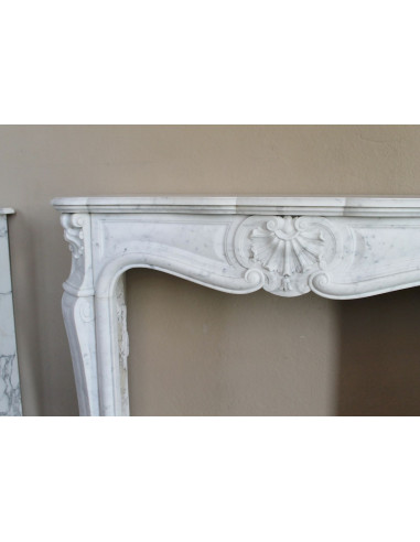 Antique Louis XV fireplace mantel in white marble, with Baroque shell motifs and exceptionally fine sculptural craftsmanship.