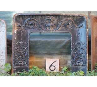 Antique cast iron insert with floral decorations for an antique marble fireplace mantel.