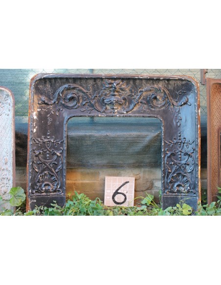 Antique cast iron insert with floral decorations for an antique marble fireplace mantel.