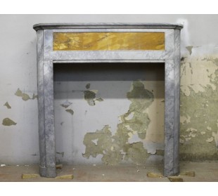 Antique Art Deco fireplace carved in Bardiglio marble with a Giallo Siena marble insert.
