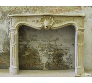 Antique stone fireplace, Louis XV “Transition” style, carved in Pierre Dorée and dating back to the 19th century.