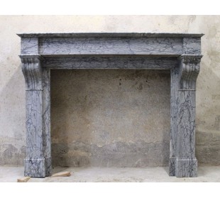 Antique Louis Philippe fireplace carved in gray floral marble. This marble mantel is called “Modillon”.