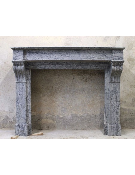 Antique Louis Philippe fireplace carved in gray floral marble. This marble mantel is called “Modillon”.