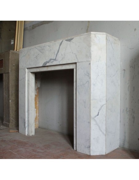 Beautiful antique Art Deco-style fireplace mantel carved in White veined Carrara marble.