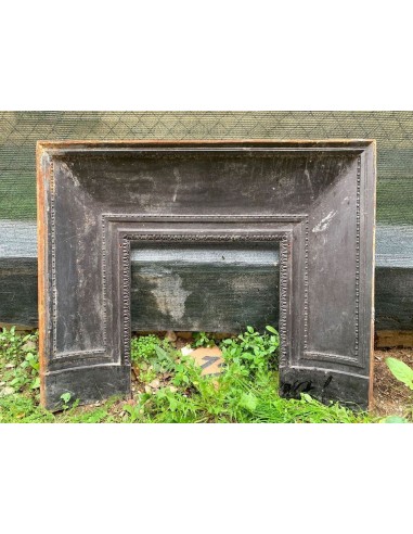 Antique cast iron insert designed to reduce the opening of a marble fireplace mantel.