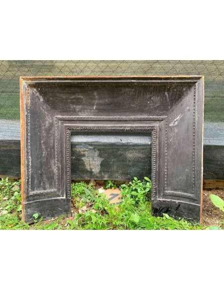 Antique cast iron insert designed to reduce the opening of a marble fireplace mantel.