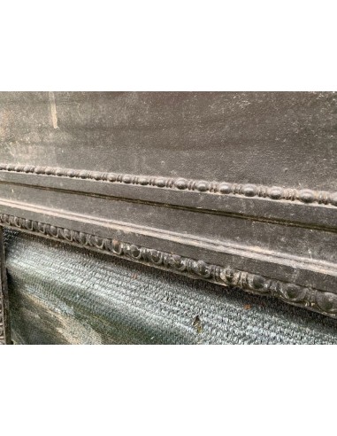 Antique cast iron insert designed to reduce the opening of a marble fireplace mantel.