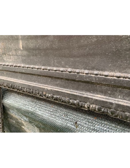 Antique cast iron insert designed to reduce the opening of a marble fireplace mantel.