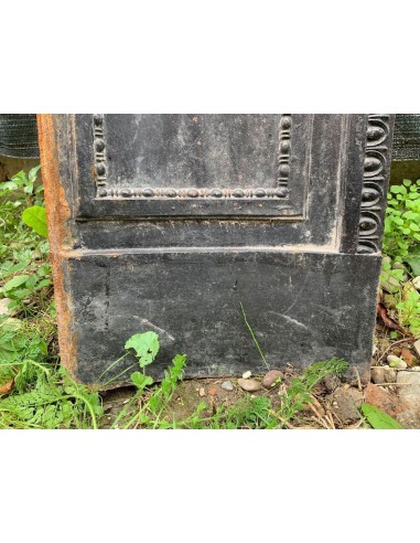 Antique cast iron insert designed to reduce the opening of a marble fireplace mantel.