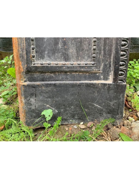 Antique cast iron insert designed to reduce the opening of a marble fireplace mantel.