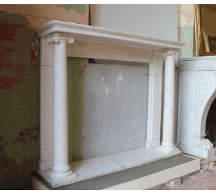 Antique fireplace mantel carved from solid Statuary marble. On either side are columns with Corinthian capitals. 2