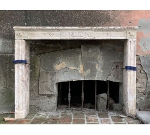 Large antique fireplace carved in light, beige, beaujolais stone.