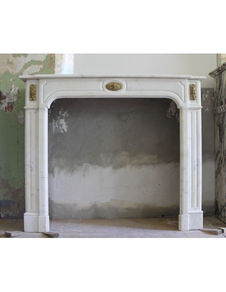 Original Louis XIV fire surround in white Statuary marble with refined decorated bronzes.