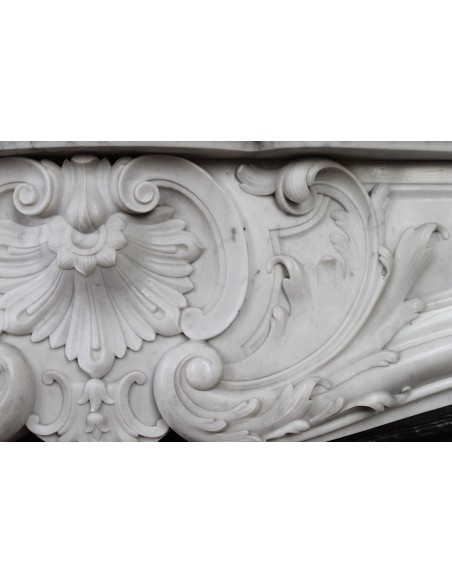 027 AG ANTIQUE LOUIS XV "ROSACES" FIREPLACE MANTEL CARVED IN WHITE CARRARA MARBLE WITH ITS OWN ORIGINAL FLORAL CAST IRON INSERT