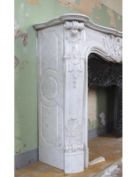 027 AG ANTIQUE LOUIS XV "ROSACES" FIREPLACE MANTEL CARVED IN WHITE CARRARA MARBLE WITH ITS OWN ORIGINAL FLORAL CAST IRON INSERT