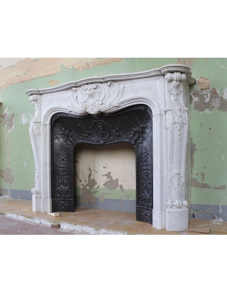 027 AG ANTIQUE LOUIS XV "ROSACES" FIREPLACE MANTEL CARVED IN WHITE CARRARA MARBLE WITH ITS OWN ORIGINAL FLORAL CAST IRON INSERT