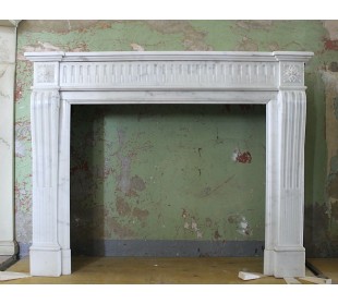 Antique Neoclassical fireplace mantel carved in White Pure Statuary Carrara marble. This mantel dates back to the 19th century.
