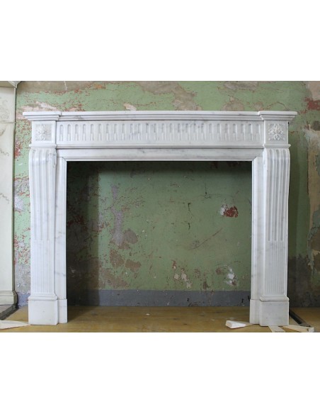 Antique Neoclassical fireplace mantel carved in White Pure Statuary Carrara marble. This mantel dates back to the 19th century.