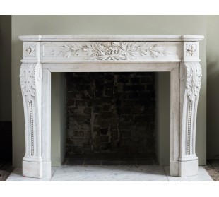 Exceptional Louis XVI fireplace mantel carved in white Carrara marble. This amazingly decorated fireplace is one-of-a-kind.