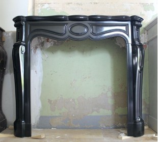 Antique Louis XV "Pied Galbé" fireplace mantel sculpted out of Black Belgian marble.