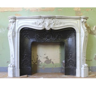 Antique Louis XV mantel carved in white Carrara marble with its own original cast iron insert.