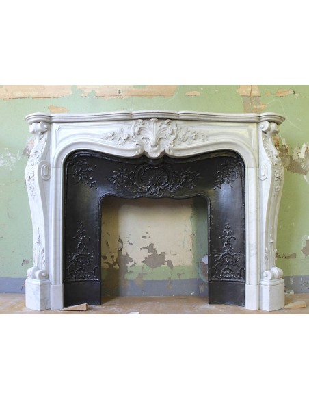 Antique Louis XV mantel carved in white Carrara marble with its own original cast iron insert.