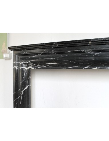 Antique Bolection mantelpiece carved in Black Marquinia marble. This fireplace comes from Paris and it is a truly unique piece.