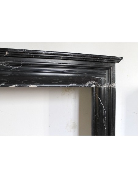 Antique Bolection mantelpiece carved in Black Marquinia marble. This fireplace comes from Paris and it is a truly unique piece.
