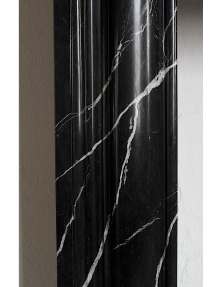 Antique Bolection mantelpiece carved in Black Marquinia marble. This fireplace comes from Paris and it is a truly unique piece.
