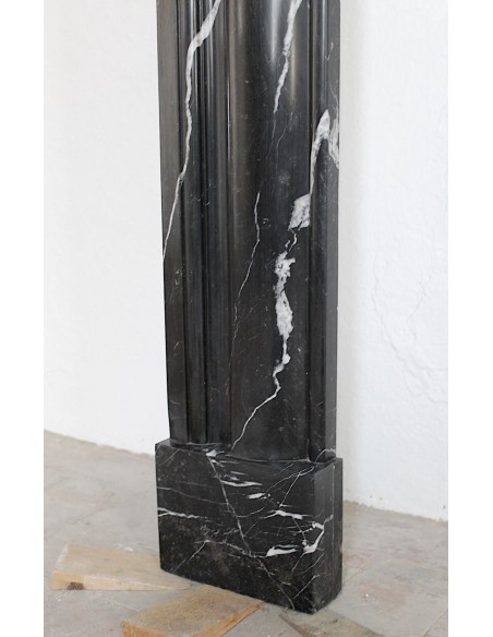 Antique Bolection mantelpiece carved in Black Marquinia marble. This fireplace comes from Paris and it is a truly unique piece.