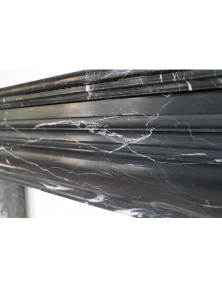 Antique Bolection mantelpiece carved in Black Marquinia marble. This fireplace comes from Paris and it is a truly unique piece.