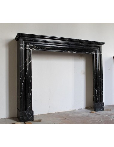 Antique Bolection mantelpiece carved in Black Marquinia marble. This fireplace comes from Paris and it is a truly unique piece.