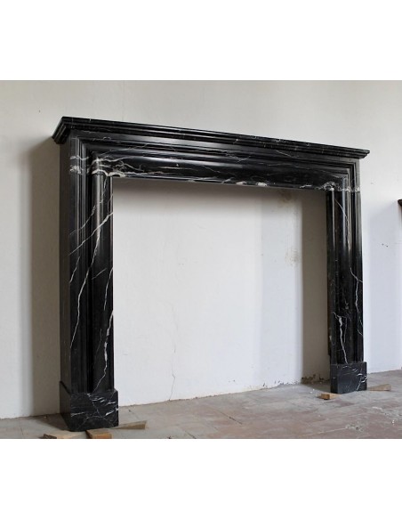 Antique Bolection mantelpiece carved in Black Marquinia marble. This fireplace comes from Paris and it is a truly unique piece.