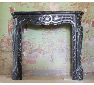 Antique Louis XV fireplace mantel carved in black Marquinia marble, with white veins.