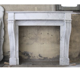 Antique White Carrara marble fireplace mantel. The marble of this fireplace comes from Italy, while its design comes from Paris.