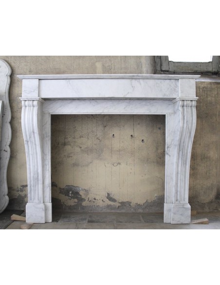 Antique White Carrara marble fireplace mantel. The marble of this fireplace comes from Italy, while its design comes from Paris.