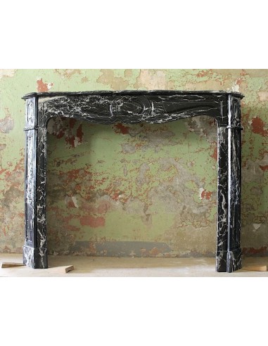 Antique Black Marquinia marble fireplace mantel. This fire surround is baroque style