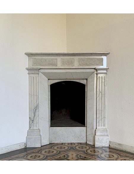 Art Nouveau period marble fireplace carved in Carrara marble. This antique mantel can be mounted at an angle.